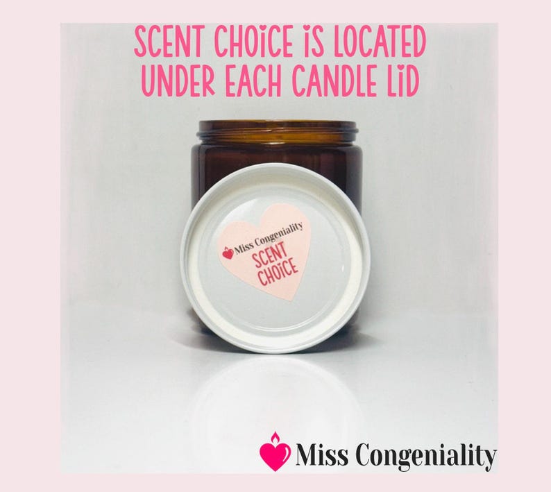 May include: A brown glass candle jar with a white lid. The lid has a pink heart with the text "Miss Congeniality Scent Choice" on it. The text "Scent Choice is located under each candle lid" is written in black text on a pink background.