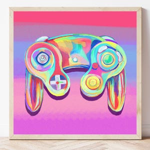 May include: A colorful, abstract painting of a video game controller. The controller features a cross-shaped directional pad, buttons, and joysticks. The artwork uses a vibrant palette of rainbow colors, set against a pink and purple background, framed in a light wood.