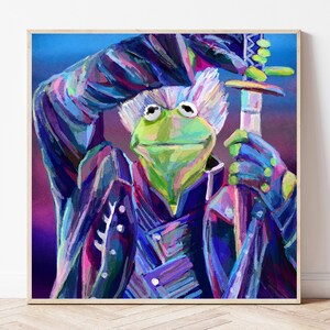 May include: A framed art print featuring a green frog character in a colorful, stylized illustration. The frog is depicted holding a sword and wearing a dark blue and purple outfit. The artwork has a whimsical and vibrant aesthetic.