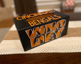 May include: Black tissue box cover with orange and white "Cincinnati Bengals" and "Who Dey" text. The box has a tiger stripe pattern.