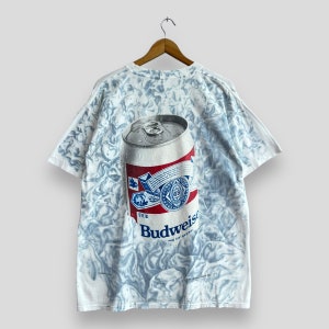 May include: White t-shirt with a tie-dye pattern and a large graphic of a Budweiser beer can. The can is blue, red, and white with the Budweiser logo.