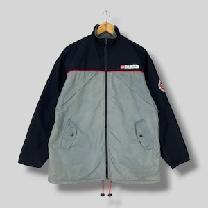 May include: A two-tone zip-up jacket featuring a dark navy upper section and a light gray lower section, separated by a thin red horizontal line. The jacket includes a front zipper, two flap pockets, and the Ecko Unltd. logo on the chest and sleeve.