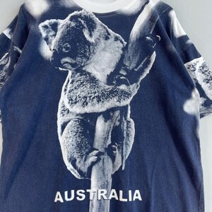 May include: A navy blue t-shirt with a white koala bear graphic and the word "AUSTRALIA" printed on the bottom.