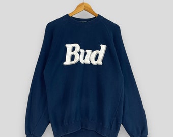 May include: A navy blue sweatshirt with a white "Bud" logo printed on the front.