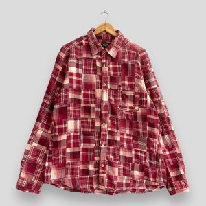 Könnte beinhalten: Ein langärmliges, rot-weiß kariertes Hemd mit Knöpfen und Patchwork-Muster. Das Hemd hat eine einzelne Brusttasche.
