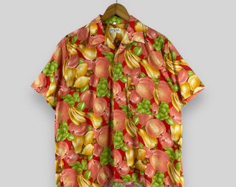 May include: A red short-sleeved button-up shirt with a tropical fruit print. The shirt features a variety of fruits, including bananas, pears, and peaches.