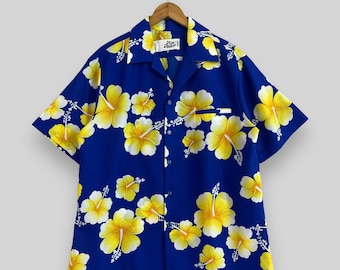 May include: A blue short-sleeved shirt with a yellow hibiscus flower pattern. The shirt has a button-up front and a collar. The label on the shirt reads "Aloha Nation".