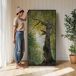 May include: A large rectangular framed wall art piece featuring a detailed oil painting of a tall, textured tree trunk in a lush forest setting with vibrant green and yellow foliage, displayed in a dark brown frame against a white wall.