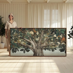May include: A large rectangular wall art piece featuring a detailed painting of a sprawling tree with textured brown bark, dense dark green foliage, and scattered white blossoms, all enclosed within a thin, dark wooden frame.