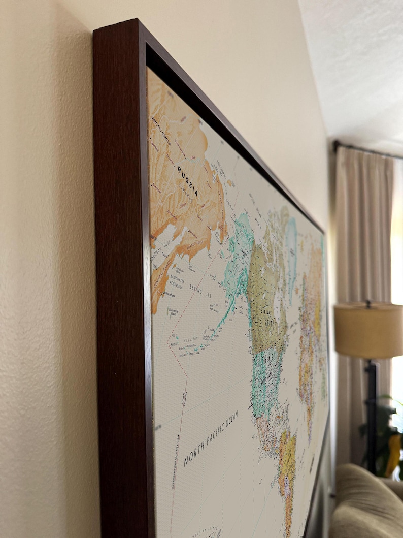 a large world map hanging on a wall, with the countries and regions clearly visible.