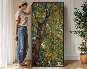 May include: A large rectangular framed wall art piece featuring a detailed painting of a tree with a thick brown trunk and dense green and yellow foliage. The artwork is displayed in a dark brown frame, showcasing a naturalistic view of branches.