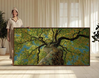 May include: A rectangular wall art print featuring a low-angle perspective of a large tree with a thick, textured trunk and sprawling branches covered in dense green and yellow foliage against a clear blue sky, framed in a thin dark wood border.