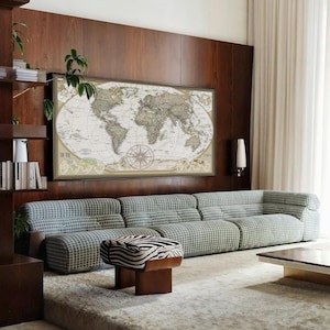 a living room with a large world map on the wall, a long sofa, a coffee table, and a zebra-patterned ottoman.