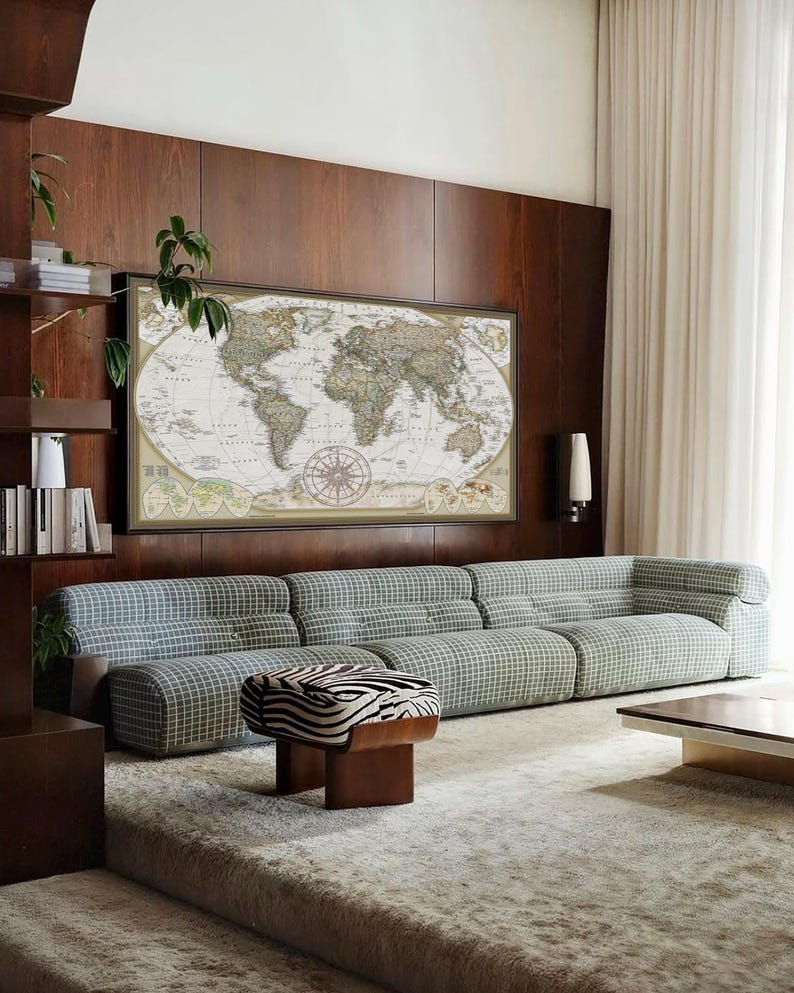 a living room with a large world map on the wall, a long sofa, a coffee table, and a zebra-patterned ottoman.