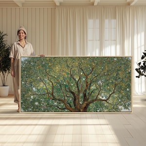 May include: A large rectangular wall art piece featuring a detailed painting of a sprawling tree with dense green foliage, brown branches, and scattered white and yellow blossoms, encased in a simple light-colored wooden frame.