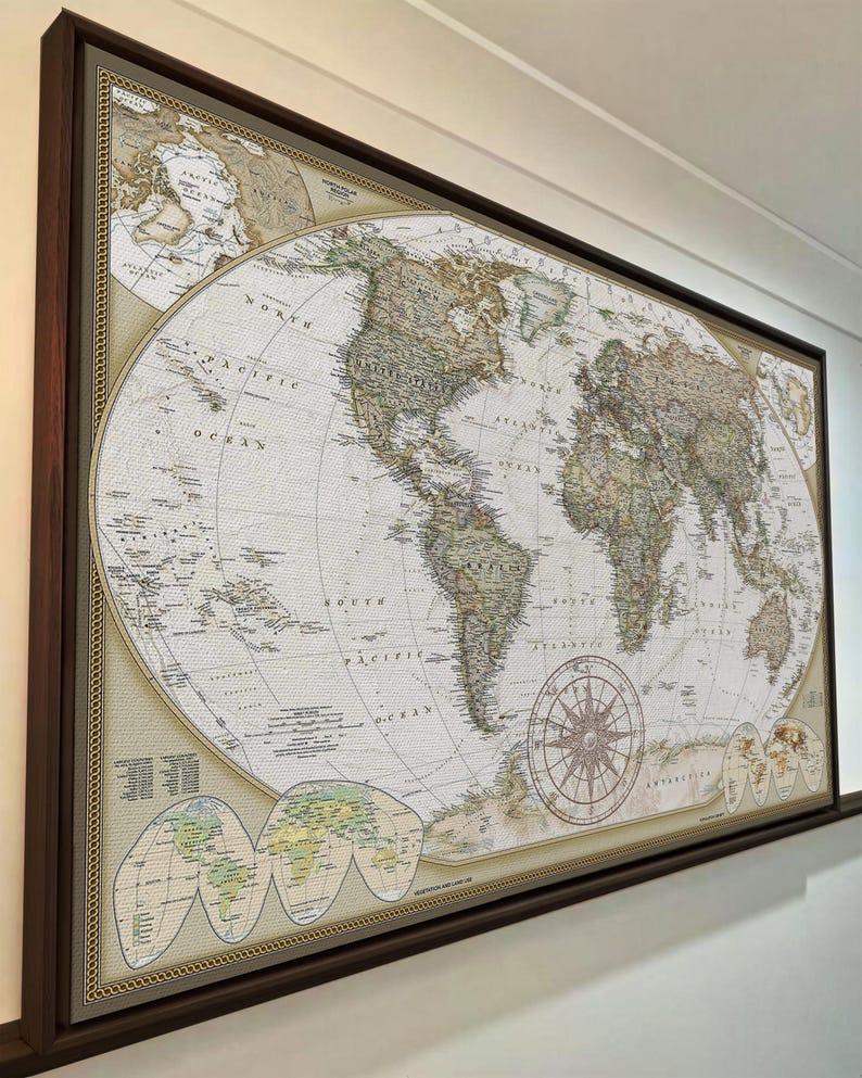 The image is a large, framed world map hanging on a wall.