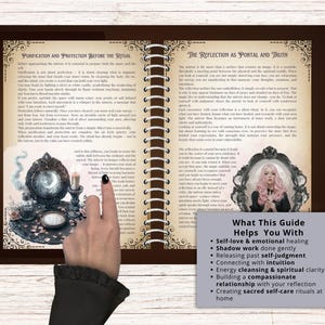 May include: Open book with brown covers and spiral binding, featuring text on purification and reflection. The pages display illustrations of mirrors and candles. A hand points to a guide with bullet points: self-love, emotional healing, shadow work, and intuition.