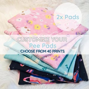 May include: A selection of patterned pee pads in a stack, featuring designs like bunnies and floral motifs. The pads are in pink, blue, and black. The image text says "Customize Your Pee Pads" and "Choose from 40 Prints".