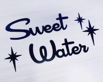 May include: Black vinyl lettering with the words "Sweet Water" and two black star shapes.