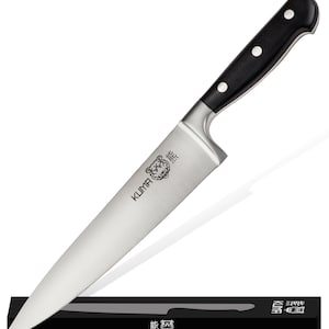 May include: A black handled chef's knife with a silver blade and a tiger logo on the blade. The knife is resting on a black magnetic knife holder with the same tiger logo.
