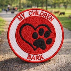 May include: Embroidered patch with the text "MY CHILDREN BARK" in a circular design. The patch features a red heart with a black paw print in the center, surrounded by a white border. The patch is likely for dog lovers.