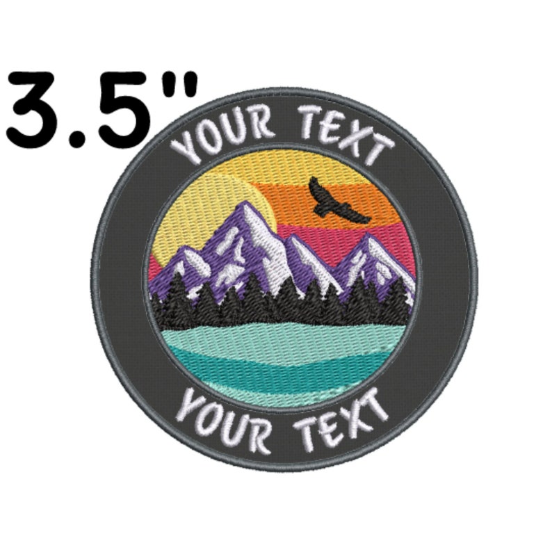 May include: A 3.5 inch embroidered patch with a mountain scene. The patch features a sunset with a flying bird, mountains, trees, and a lake. The text "YOUR TEXT" appears twice on the patch.