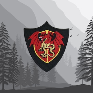 May include: A black shield with a red dragon inside. The dragon has yellow wings and claws. The shield has a red and yellow border.