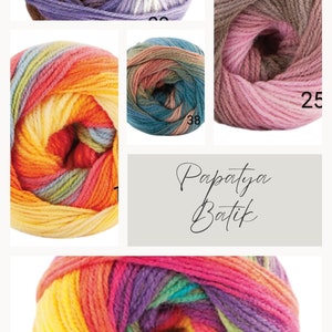 May include: A close-up of a ball of colourful yarn with a rainbow of colours, including yellow, orange, red, purple, and green. The yarn is labelled "Papatya Batik".