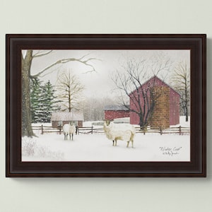 May include: Framed winter scene painting of a red barn with snow on the ground and two white sheep in the foreground. The painting is titled "Winter Coat" by Kelly  Pruitt.
