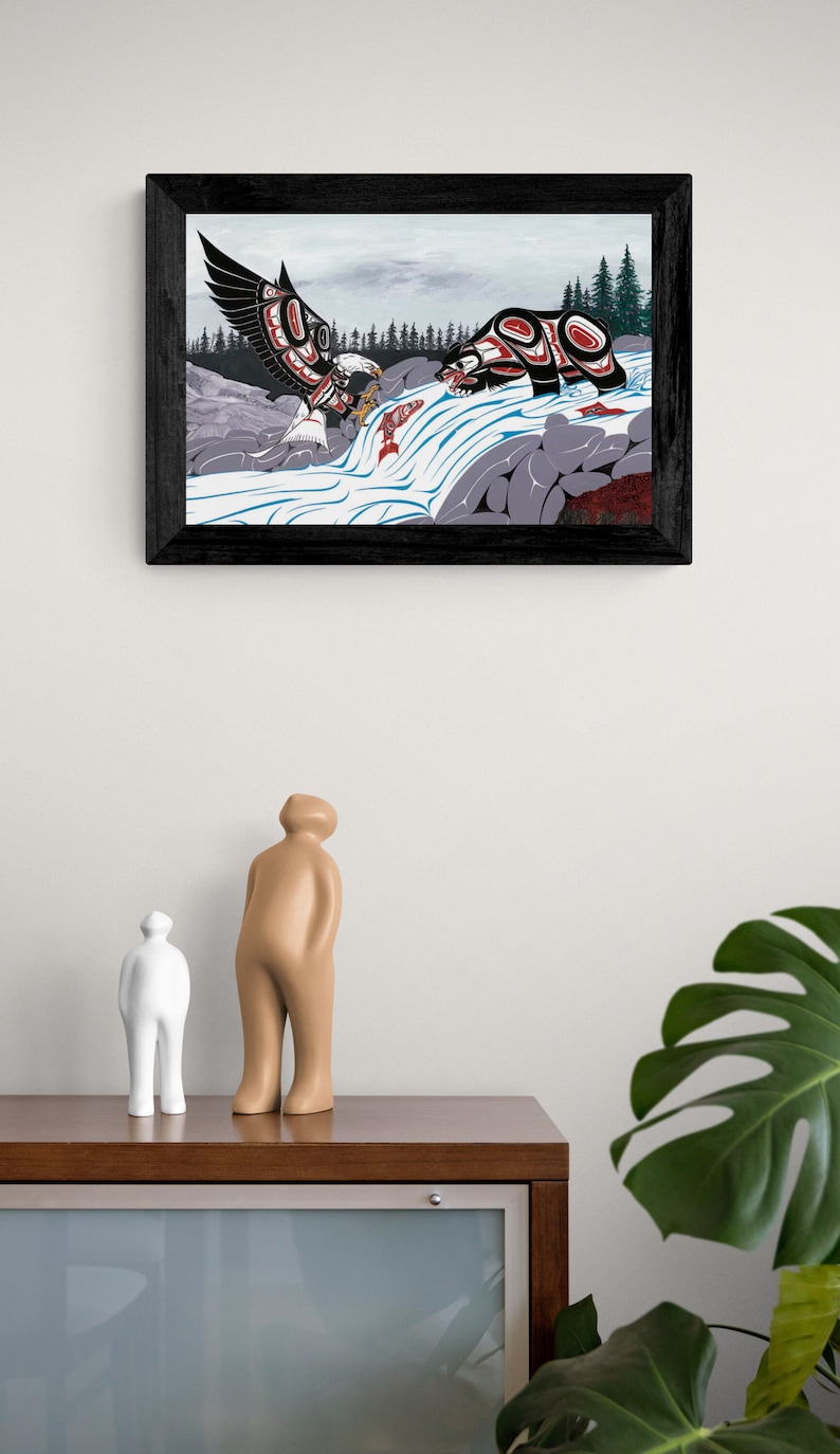 May include: A framed print of a stylized Native American art piece depicting a bear and an eagle fighting over a salmon in a river. The artwork is done in a colorful style with geometric shapes and patterns.