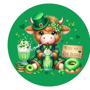 May include: A cartoon highland cow wearing a green hat and holding a green milkshake. The cow is surrounded by green shamrocks, hearts, and donuts. The sign says "Kiss Me I'm Irish".