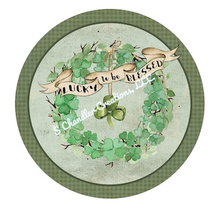 May include: A green shamrock wreath with a banner that reads "Lucky to be Blessed". The wreath is decorated with green shamrocks and a gold bell.