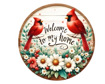 May include: A round wooden sign with a whitewashed background featuring two red cardinals perched on branches. The sign is decorated with white and red flowers and the text "Welcome to my home" in a cursive font.