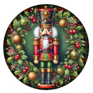 May include: A round Christmas ornament featuring a festive nutcracker soldier in a red, green, and black uniform. The nutcracker is surrounded by a wreath of holly, berries, and ornaments, set against a plaid background.