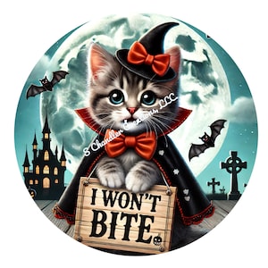 May include: A cute cartoon cat dressed as a vampire with a witch's hat, holding a sign that says "I won't bite". The cat is surrounded by Halloween decorations, including a castle, bats, and a graveyard.