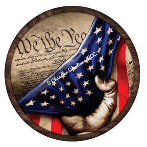 May include: A round wooden plaque with a distressed American flag draped over the text "We the People" from the US Constitution. The flag is held by a hand reaching out from behind the text.