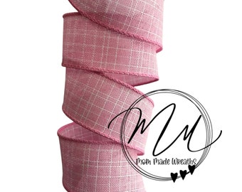 1.5 light pink wired ribbon with base layer of pink and white stitching.