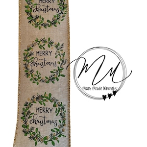 May include: A decorative ribbon with a natural linen texture. The ribbon features repeating circular wreaths with the text "MERRY Christmas" in a script font, accented with green leaves and gold glitter.