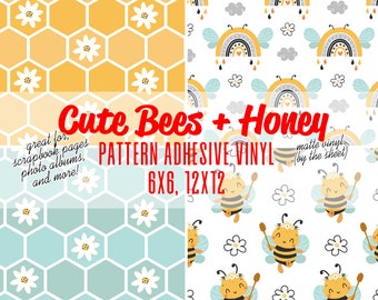 May include: Two digital paper patterns featuring cute bees and honey. The first pattern is a honeycomb design with white daisies. The second pattern features bees with honey sticks, rainbows, and white daisies on a white background. The text "Cute Bees + Honey" is displayed in the center of the image. The text "PATTERN ADHESIVE VINYL" is displayed below the title. The text "6X6, 12X12" is displayed below the pattern name. The text "matte vinyl (by the sheet)" is displayed in the upper right corner of the image.