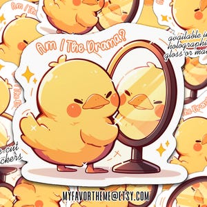 May include: A die-cut sticker featuring a yellow cartoon duck looking in a mirror. The duck has rosy cheeks and is styled in a cute, cartoonish way. The text "Am I The Drama?" is above the duck. The sticker is available in holographic, gloss, or matte finishes.
