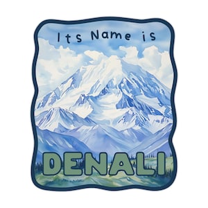 May include: A sticker featuring a watercolor painting of Denali mountain. The image shows a snow-covered mountain range under a blue sky. The text "Its Name is DENALI" is printed on the sticker.