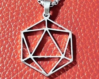 May include: A silver geometric pendant necklace featuring a polyhedron design. The pendant hangs from a silver chain. The background is a textured, reddish-orange surface.