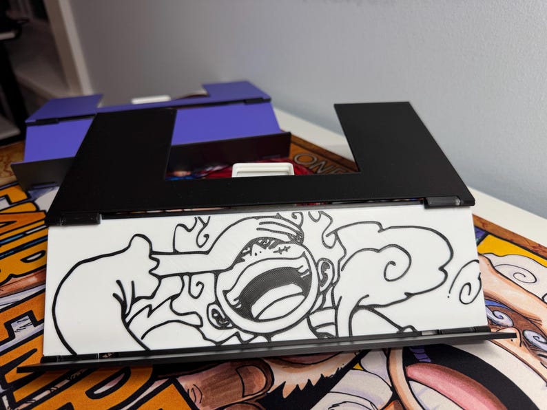 May include: A black frame with a white background and a black and white drawing of a cartoon character with a large smile and a cloud behind them. The character is covering their eyes with their hand.
