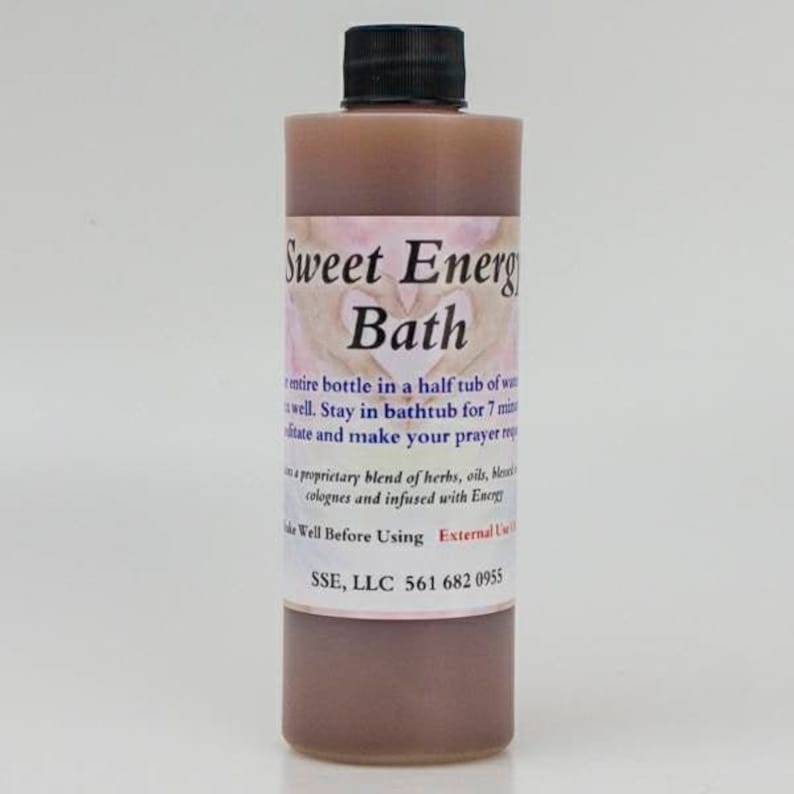 May include: A brown glass bottle with a black cap labeled "Sweet Energy Bath". The bottle contains a brown liquid and has instructions for use, including adding the entire bottle to a half tub of water and staying in the bath for 7 minutes. The label also includes the company name "SSE, LLC" and a phone number.