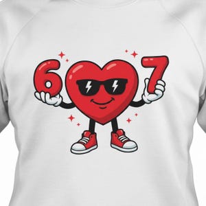 May include: White sweatshirt featuring a cartoon heart character wearing sunglasses and red sneakers. The heart holds the number 6 in one hand and the number 7 in the other. Red stars are scattered around the heart.