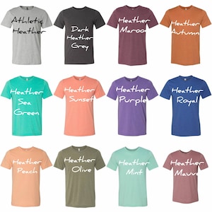 May include: Twelve different colored t-shirts with heather textures. The t-shirts are arranged in a grid of four rows and three columns. The colors are: Athletic Heather, Dark Heather Grey, Heather Maroon, Heather Autumn, Heather Sea Green, Heather Sunset, Heather Purple, Heather Royal, Heather Peach, Heather Olive, Heather Mint, and Heather Mauve.