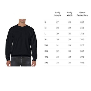 May include: Size chart for a black sweatshirt with measurements in inches for body length, body width, and sleeve center back. Sizes range from S to 5XL.