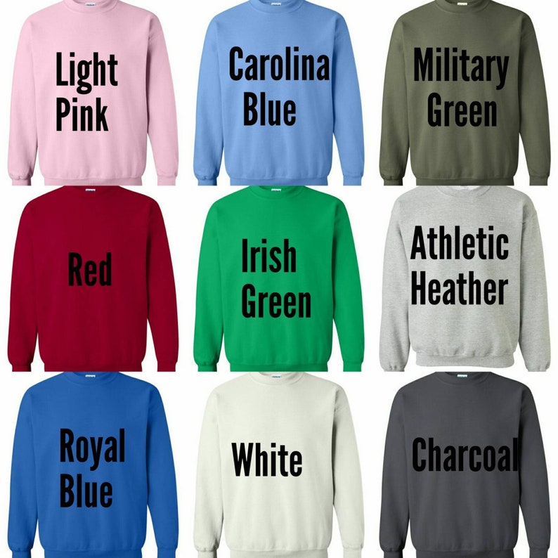May include: Nine different color sweatshirts with text on the front. The colors are light pink, Carolina blue, military green, red, Irish green, athletic heather, royal blue, white, and charcoal.