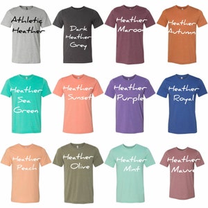 May include: Twelve different colored t-shirts with heather textures. The t-shirts are arranged in a grid of four rows and three columns. The colors are: Athletic Heather, Dark Heather Grey, Heather Maroon, Heather Autumn, Heather Sea Green, Heather Sunset, Heather Purple, Heather Royal, Heather Peach, Heather Olive, Heather Mint, and Heather Mauve.