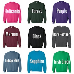 May include: Nine different color crew neck sweatshirts. The colors are Heliconia, Forest, Purple, Maroon, Black, Dark Heather, Indigo Blue, Sapphire, and Irish Green.